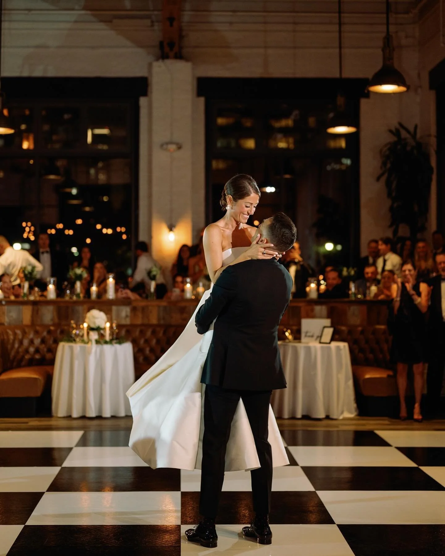 husband-and-wife-celebrating-marriage husband and wife dancing above a checker board dance floor